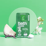 Green Llama presents its compostable lavender bathroom cleaner refill, displayed with a coconut wedge and white flowers on a mint green background.
