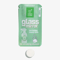 Green Llama's compostable glass and mirror cleaner refill packet displays its citrus scent and a cleaning tablet.
