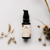 Annmarie Herbal Facial Oil for oily skin sits amongst dried flowers on a white surface.

