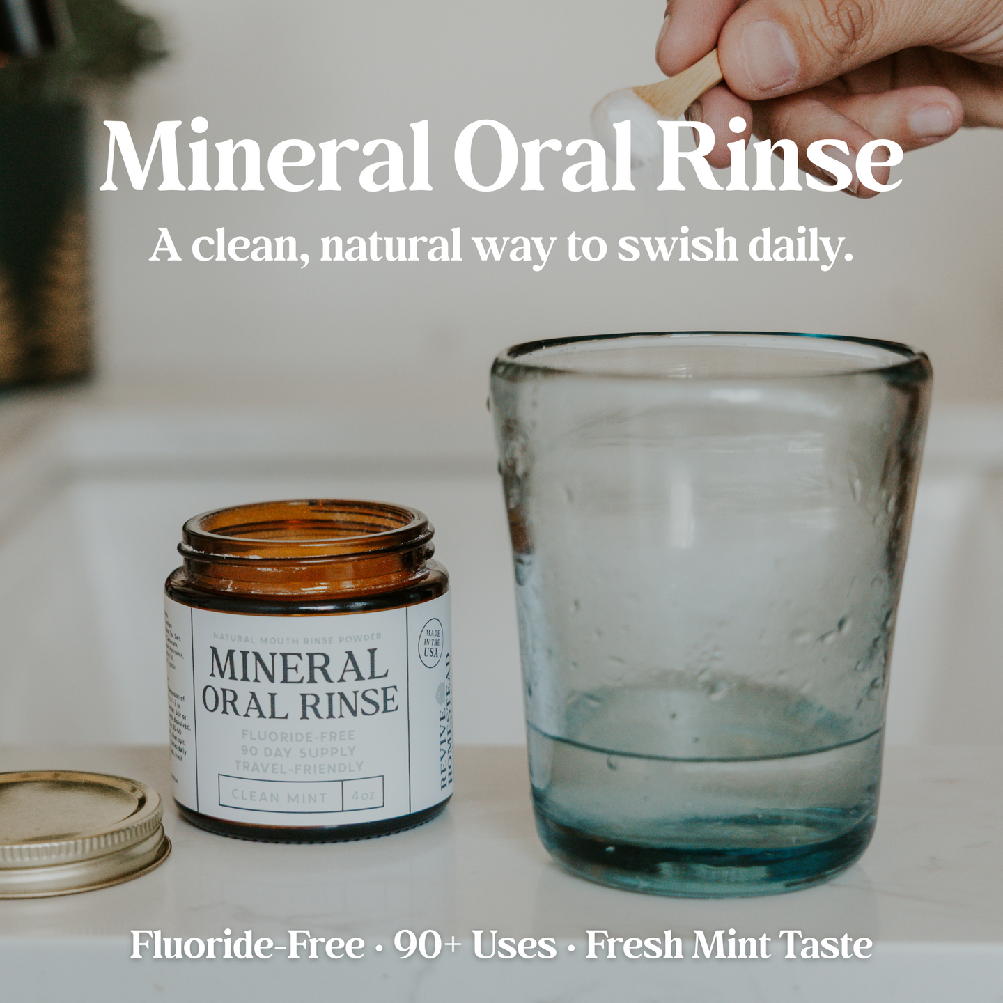A hand scoops Revive Homestead mineral oral rinse powder with a wooden spoon to mix in a glass of water.