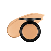 Close-up shows beige cream foundation makeup compact with a swatch.
