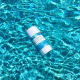 Breathe Naturals deodorant floats serenely on the surface of shimmering turquoise water.
