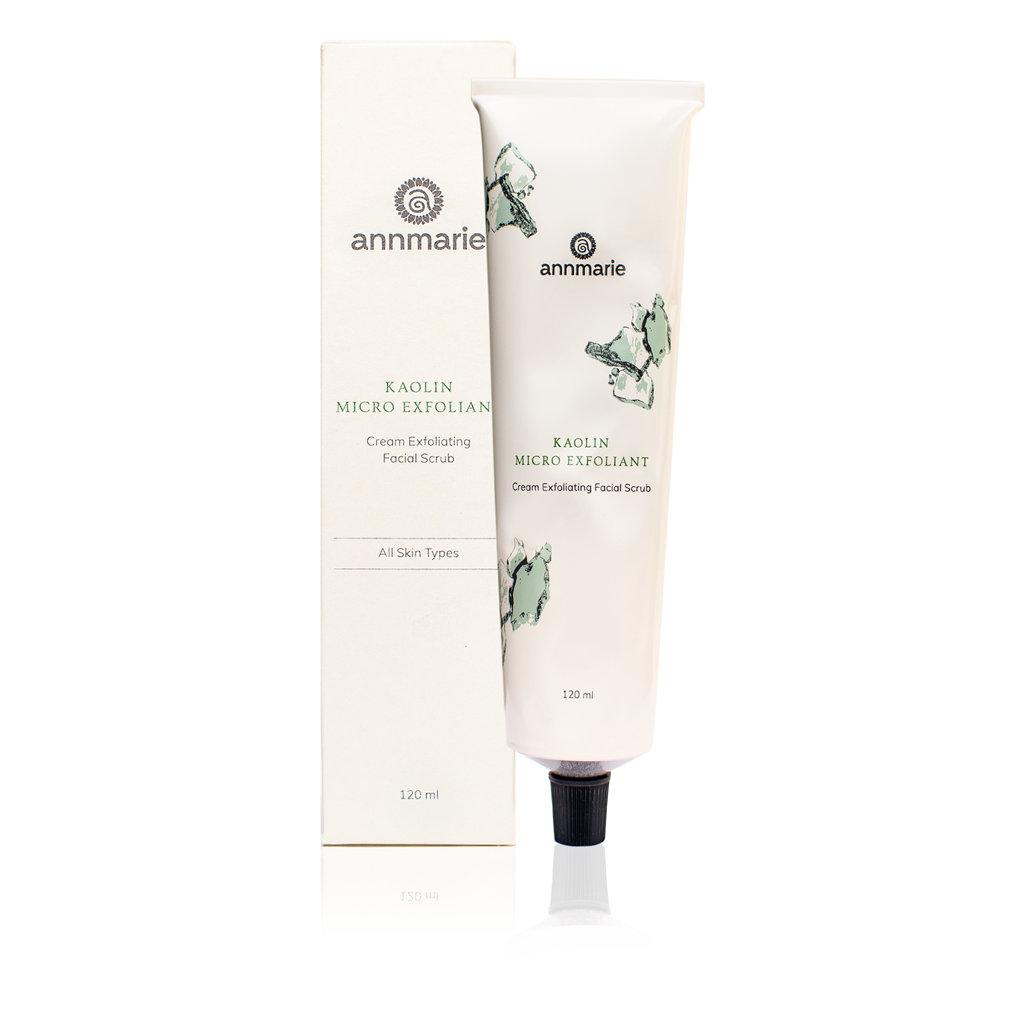 Annmarie showcases their Kaolin Micro Exfoliant cream facial scrub tube and box, highlighting their skincare product.
