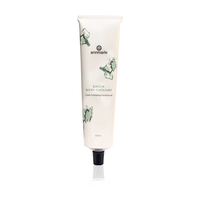 Annmarie Skin Care presents its Kaolin Micro Exfoliant cream facial scrub in a white tube with green botanical accents.
