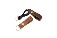 Three leather keychains, showcasing the Urban South brand, sit on a white background.
