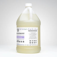 A jug of Rustic Strength laundry detergent, infused with lavender essential oil and gentle on sensitive skin, promises toxin-free, worry-free cleaning with plant-based ingredients.