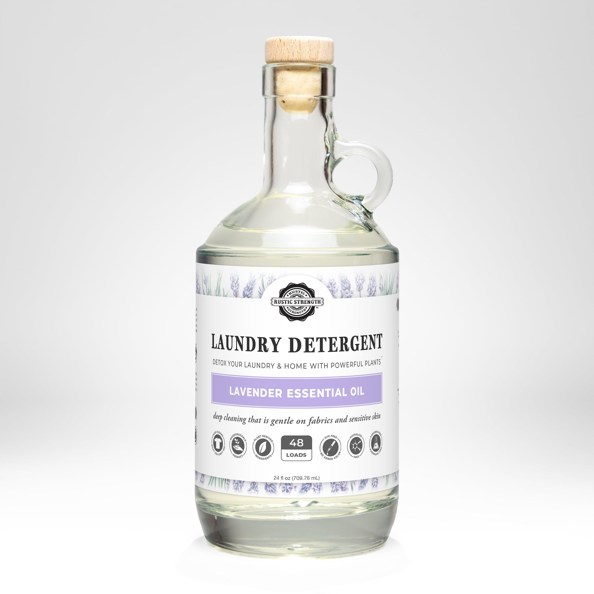 Rustic Strength sells their Lavender Essential Oil laundry detergent in a clear glass bottle with a cork stopper.
