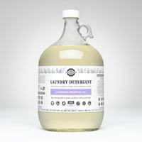 Rustic Strength lavender laundry detergent, featuring natural essential oils, sits in a clear gallon jug promising 256 loads of gentle, effective cleaning.
