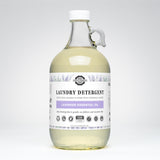Rustic Strength Lavender Essential Oil laundry detergent fills a glass jug with handle.
