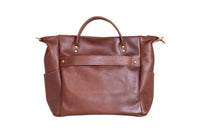 Showcases a luxurious, brown leather tote bag with top handles and side pockets.
