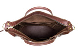 An open, dark brown leather tote bag displays its spacious interior with multiple pockets and a gold zipper.
