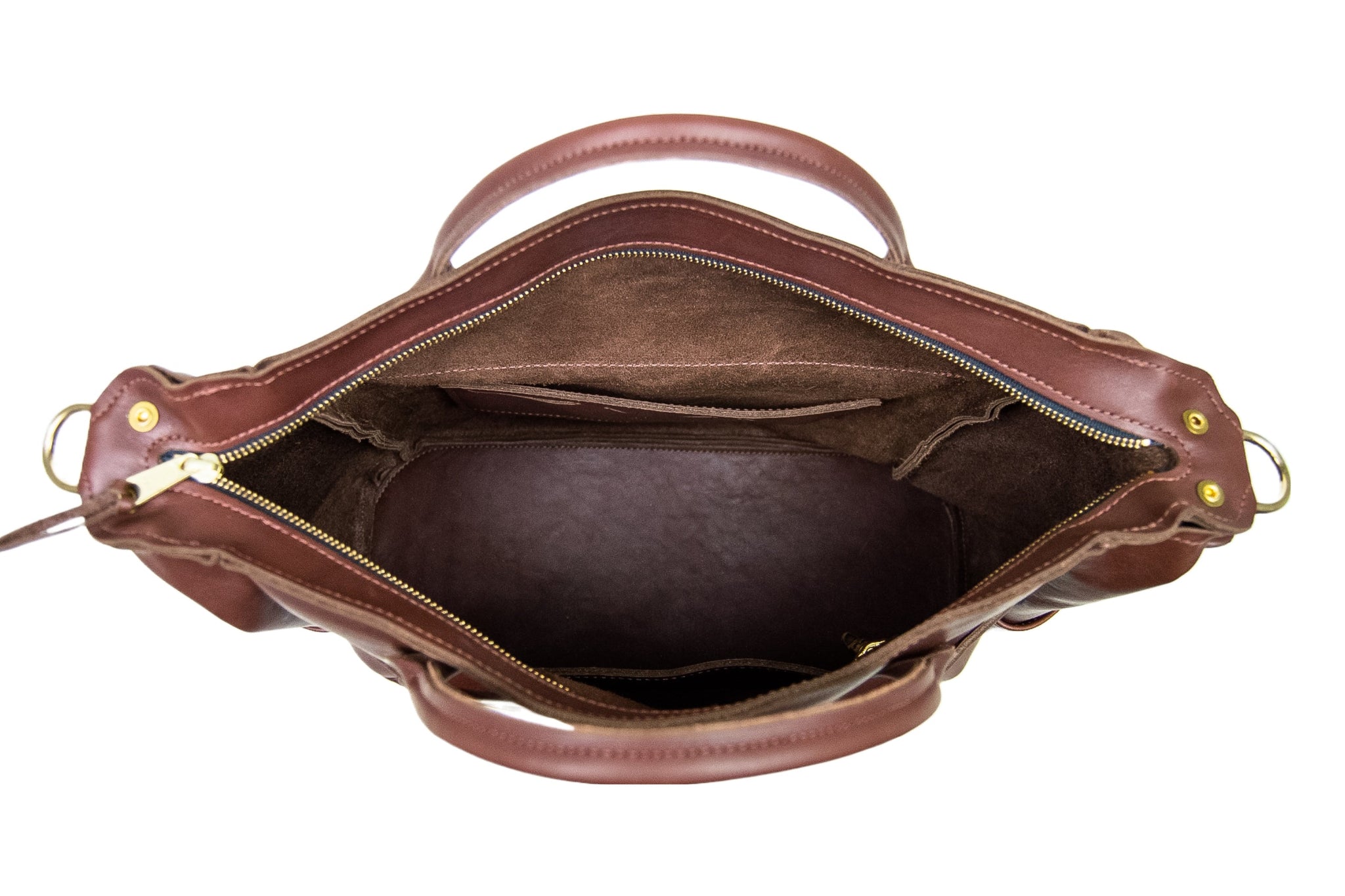 An open, dark brown leather tote bag displays its spacious interior with multiple pockets and a gold zipper.

