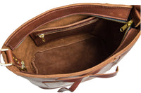 View inside a stylish brown leather tote bag reveals a zippered pocket and spacious interior.
