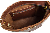 View shows the interior of a brown leather bucket bag with a zippered pocket.