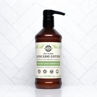 Showcases a bottle of Rustic Strength avocado face and body lotion with rosemary and mint essential oils on a white tile background.