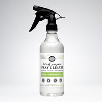 Inspect a clear spray bottle of plant-based, non-toxic Rustic Strength all-purpose cleaner featuring bergamot and cypress essential oils.