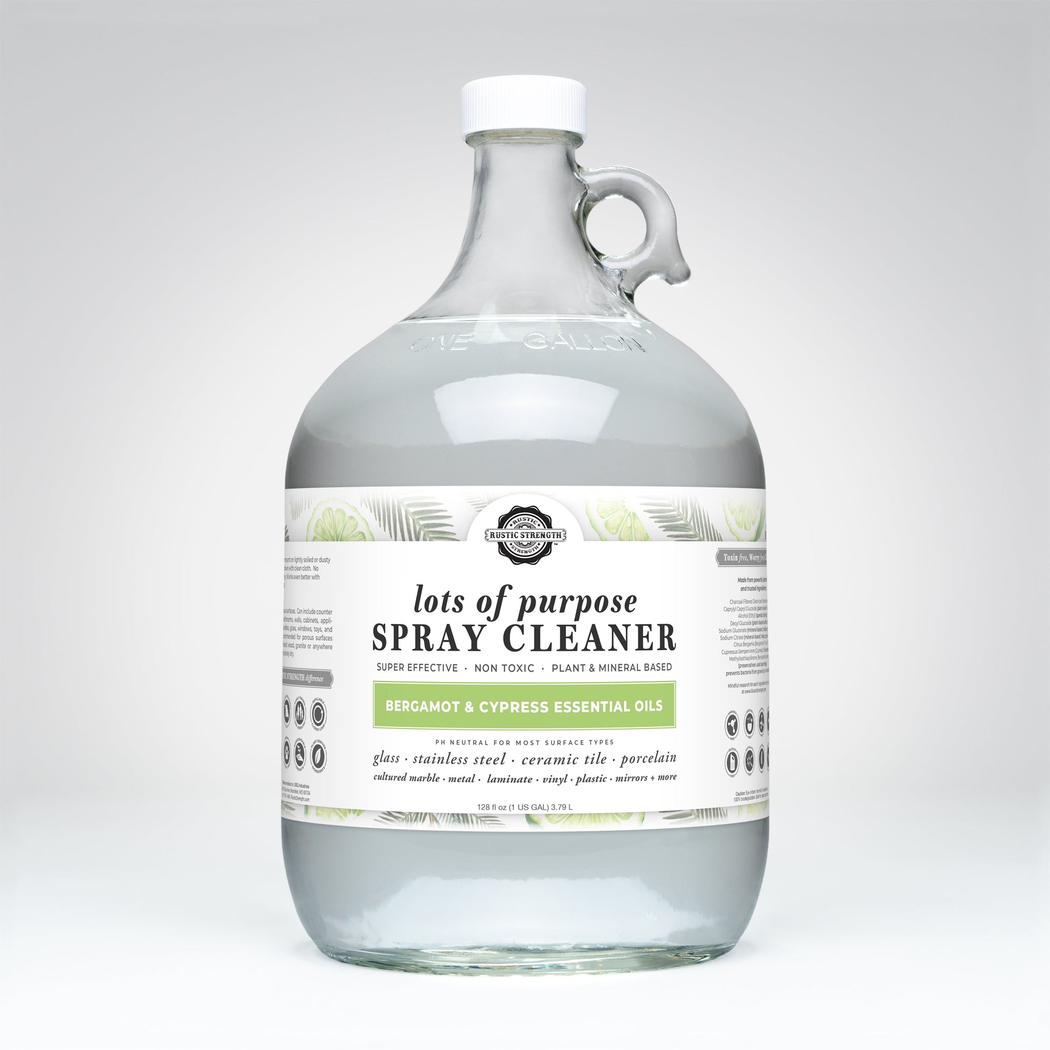 Rustic Strength's lots of purpose spray cleaner, featuring bergamot and cypress essential oils, sits in a glass jug.
