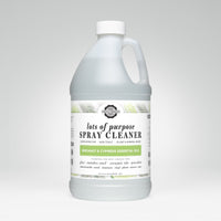 A gallon jug of Lots of Purpose Spray Cleaner with bergamot and cypress essential oils sits against a white background.