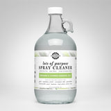 View a glass bottle filled with Rustic Strength Lots of Purpose Spray Cleaner, featuring bergamot and cypress essential oils for cleaning various surfaces.