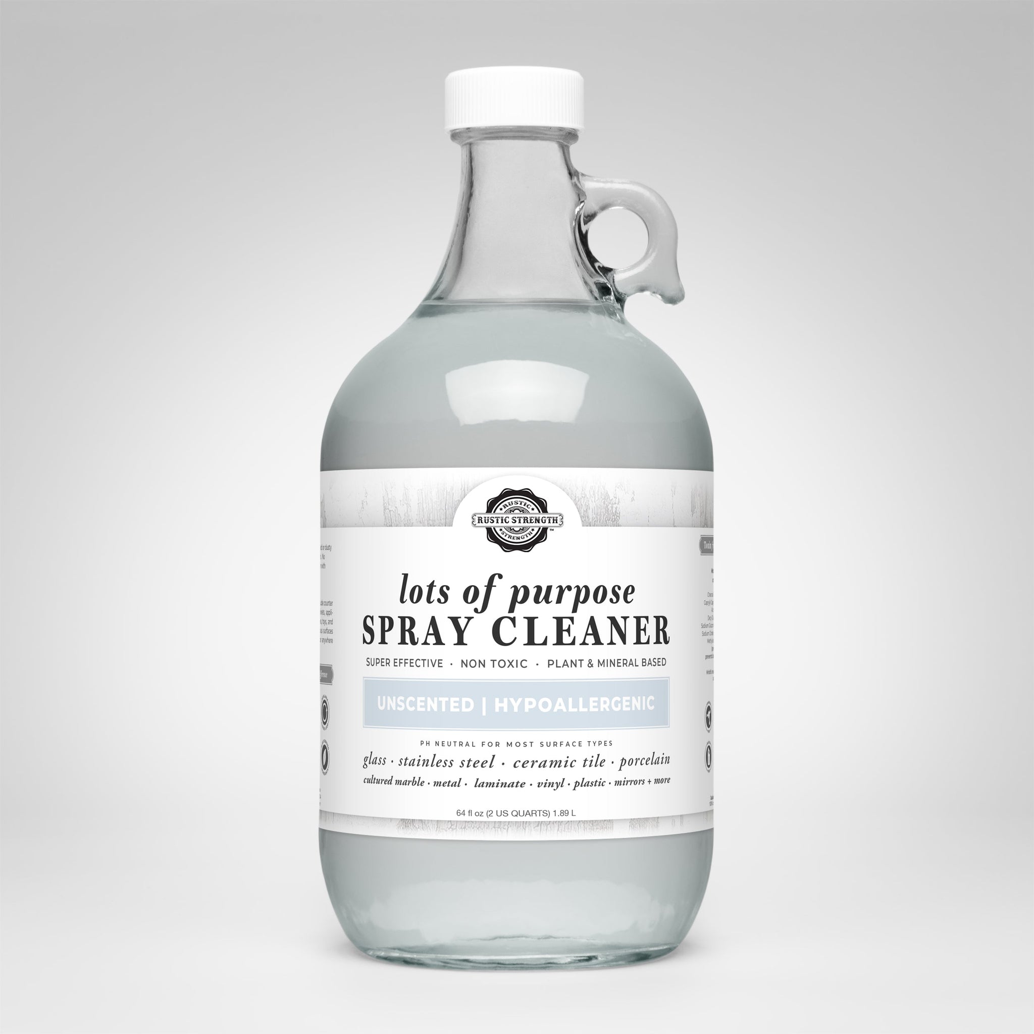 A glass jug displays Rustic Strength lots of purpose, unscented, hypoallergenic spray cleaner suitable for various surfaces.
