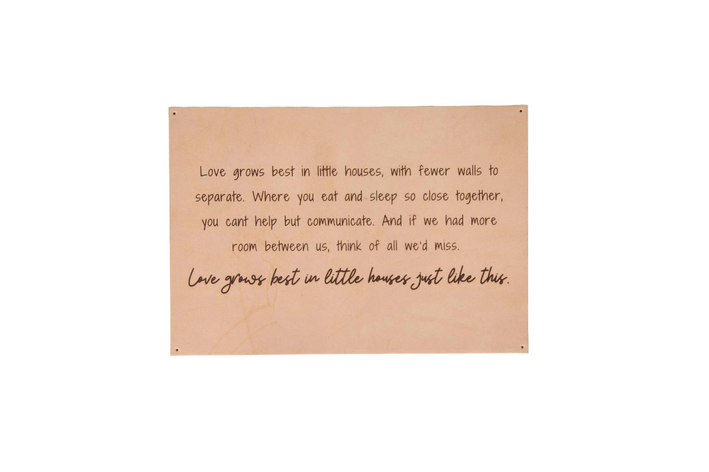 A framed wall decor sign displays a heartwarming quote about love growing best in smaller homes.
