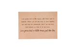 A framed wall decor sign displays a heartwarming quote about love growing best in smaller homes.
