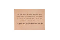 A framed wall decor sign displays a heartwarming quote about love growing best in smaller homes.
