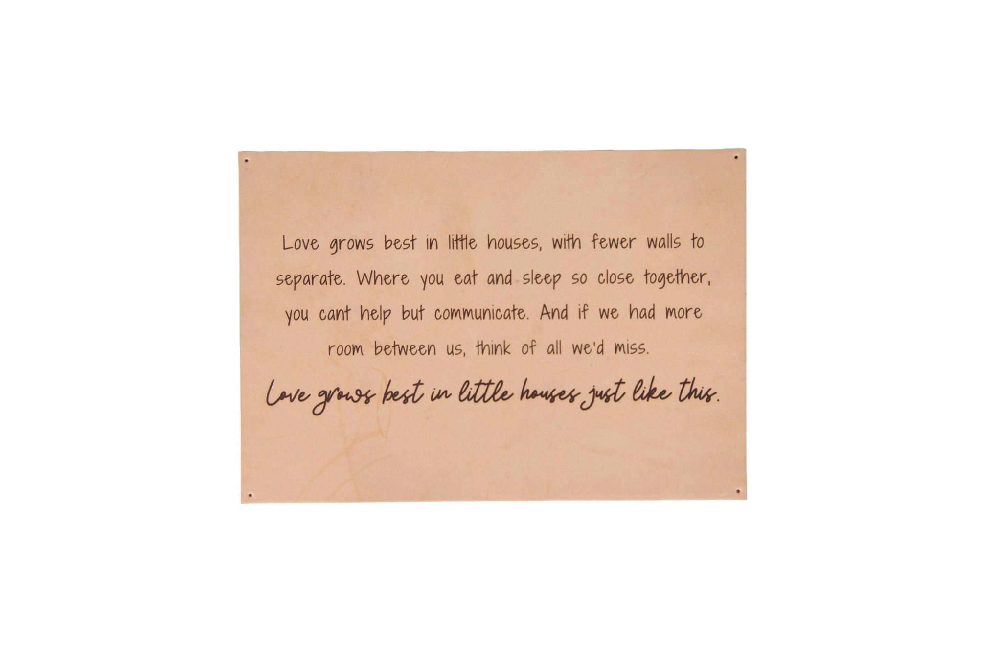 A framed wall decor sign displays a heartwarming quote about love growing best in smaller homes.
