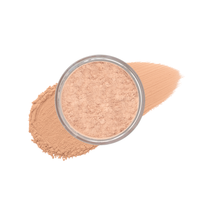 Close-up shows loose mineral powder foundation in a clear container with swatches of matching makeup.
