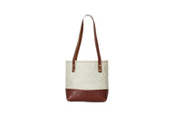 Showcases a stylish canvas tote bag with leather accents against a clean white background.
