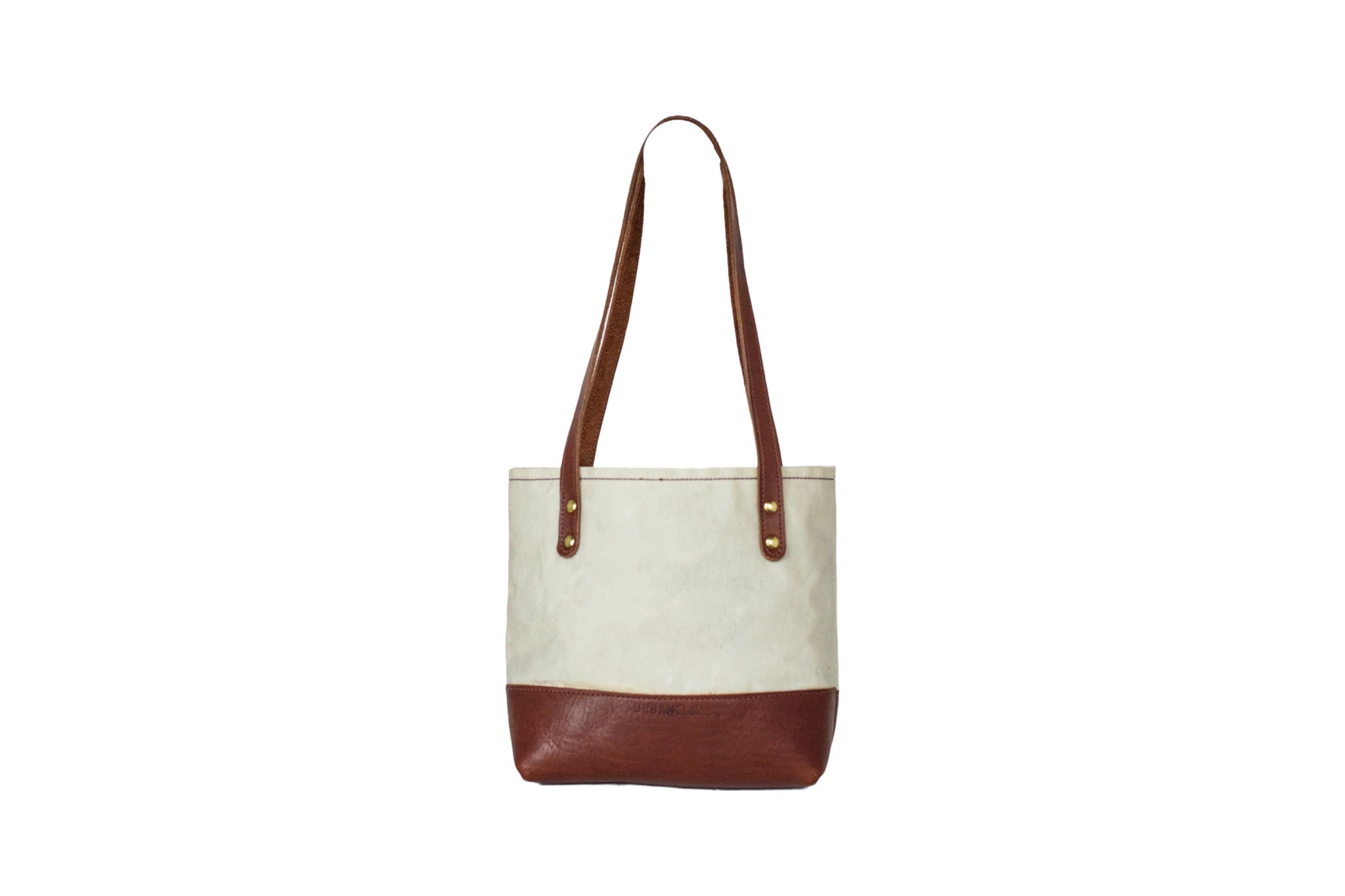 Showcases a stylish canvas tote bag with leather accents against a clean white background.
