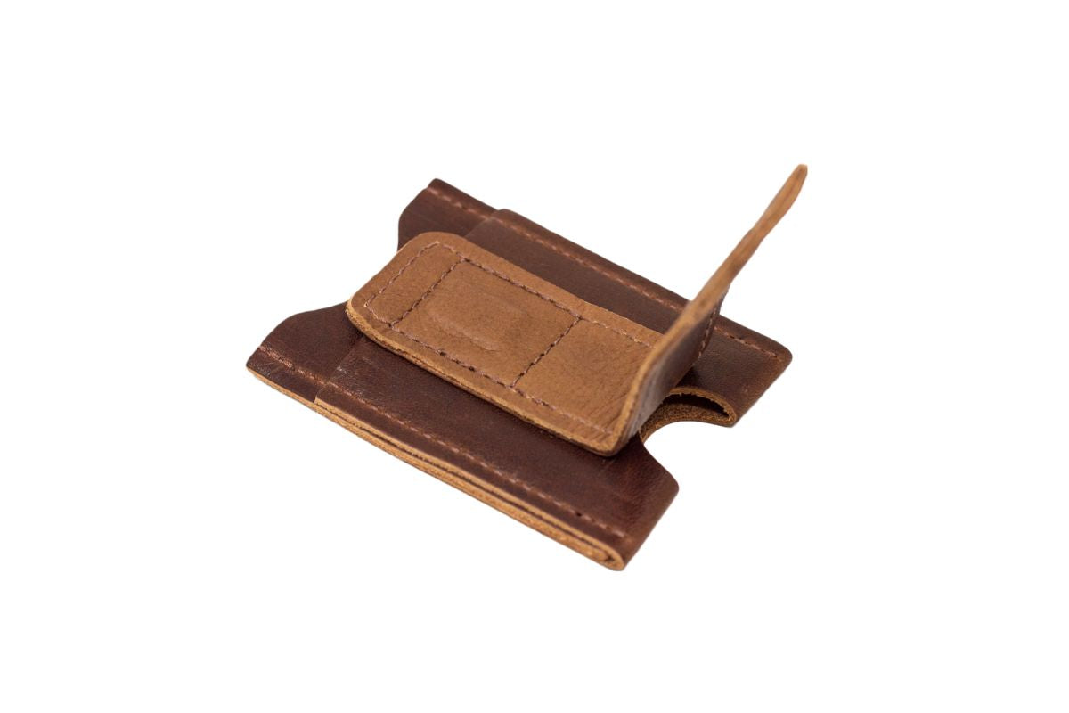 Leather money clip displays its simple, stylish design on a white background.
