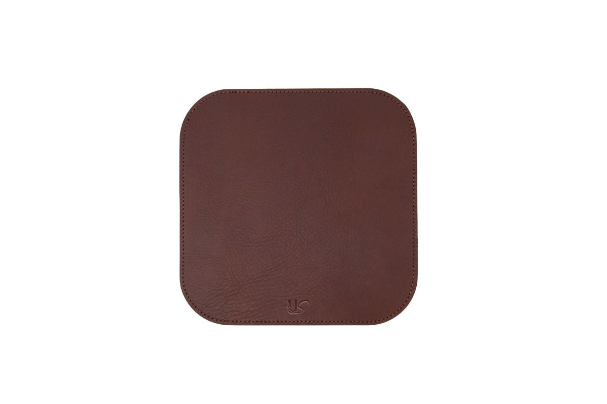 Showcases a brown leather desk pad with rounded corners and subtle stitching.
