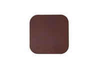 Showcases a brown leather desk pad with rounded corners and subtle stitching.
