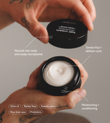 Hands hold open a jar of Jack Henry hair cream, highlighting its moisturizing and curl-defining ingredients like olive oil, barley flour, and probiotics for nourishing hair.
