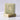 Two bars of natural, handcrafted soap rest stacked on a marble surface, displaying their unique patterns and textures.
