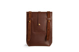 Showcases a handcrafted dark brown leather belt pouch featuring adjustable straps and brass button closure, ideal for everyday carry.
