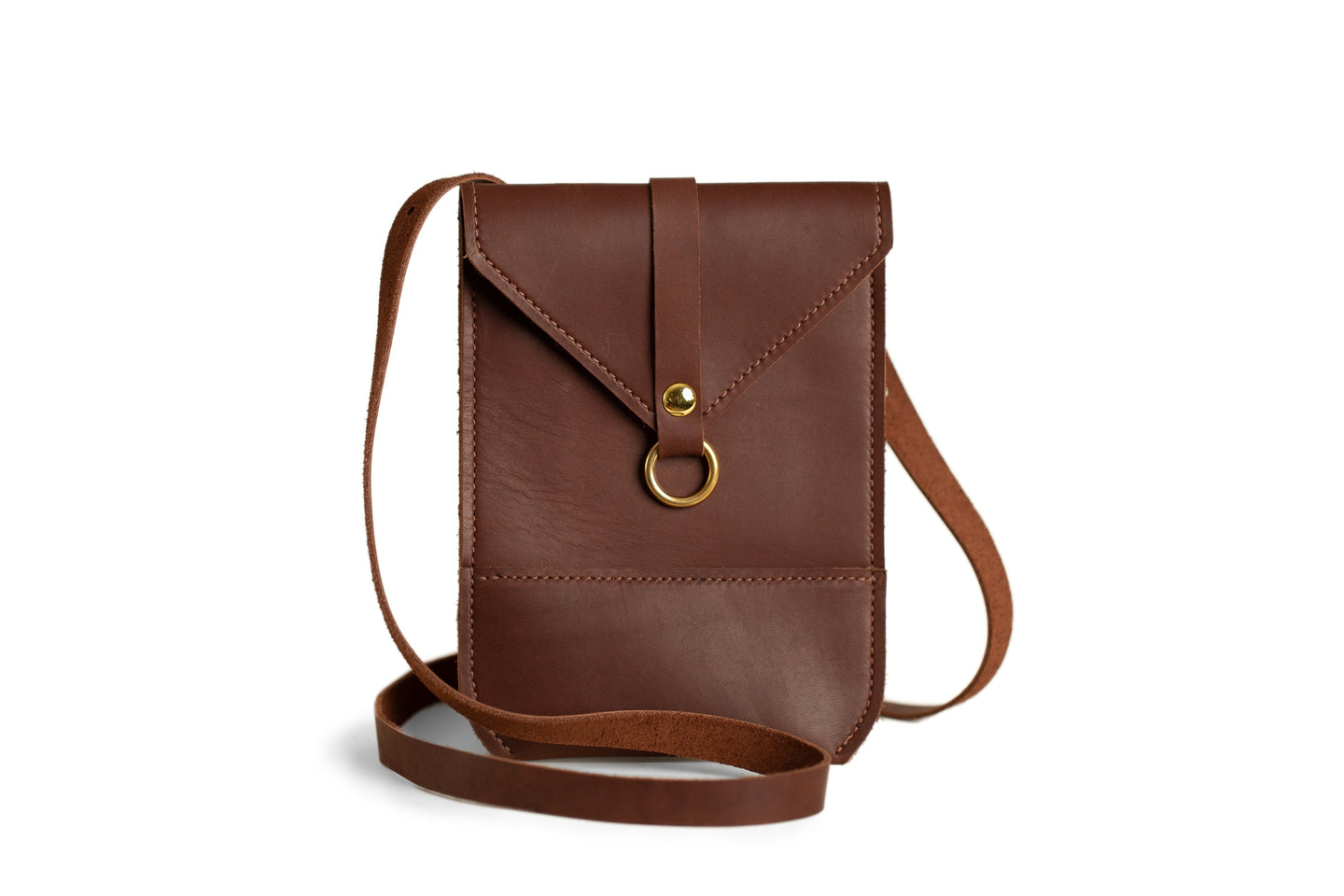 A brown leather crossbody bag with a gold clasp sits on a white background.
