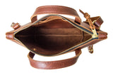 A view from above showcases the open, spacious interior of a brown leather tote bag with a zipper closure and carrying handles.
