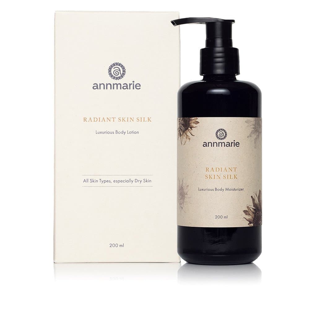 Annmarie's Radiant Skin Silk body lotion and body moisturizer, designed for all skin types especially dry skin, stand side-by-side against a white background.
