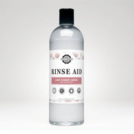 Rustic Strength Rinse Aid bottle showcases light cherry aroma, promising sparkling clean dishes without spots.
