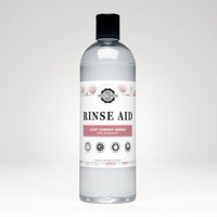Rustic Strength Rinse Aid bottle showcases light cherry aroma, promising sparkling clean dishes without spots.

