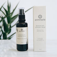 Annmarie Rosemary Toning Mist sits next to its box, advertising an energizing face, body, and hair mist suitable for all skin types.

