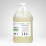 Examine a large white jug filled with Rustic Strength non-toxic shampoo made with mint essential oils and plant-based ingredients, advertised for sensitive skin.
