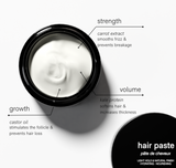 An open jar of hair paste highlights its nourishing ingredients, including castor oil for growth, carrot extract for strength, and kale protein for volume.
