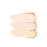 Close-up shows swatches of three shades of beige and yellow face powder foundation makeup.
