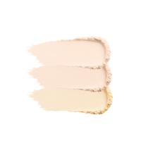 Close-up shows swatches of three shades of beige and yellow face powder foundation makeup.
