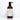 A brown bottle of Rustic Strength Soothing Shampoo with lavender and tea tree essential oils sits on a white tile surface.

