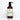 A bottle of Rustic Strength Soothing Shampoo with rosemary and mint essential oils sits against a white tile background.