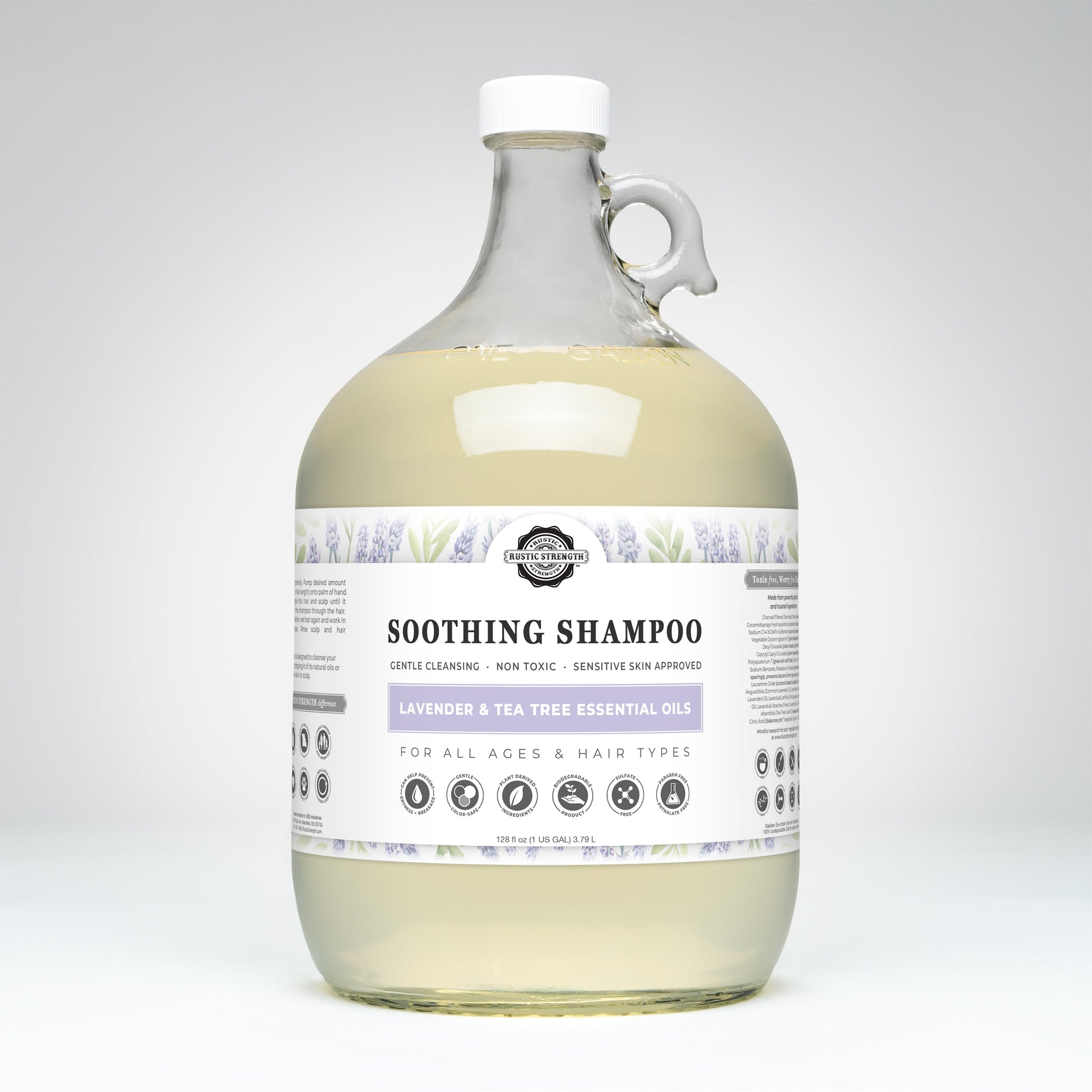 A one-gallon glass jug contains Rustic Strength Soothing Shampoo with lavender and tea tree essential oils, marketed as gentle, non-toxic, and suitable for all ages and hair types.
